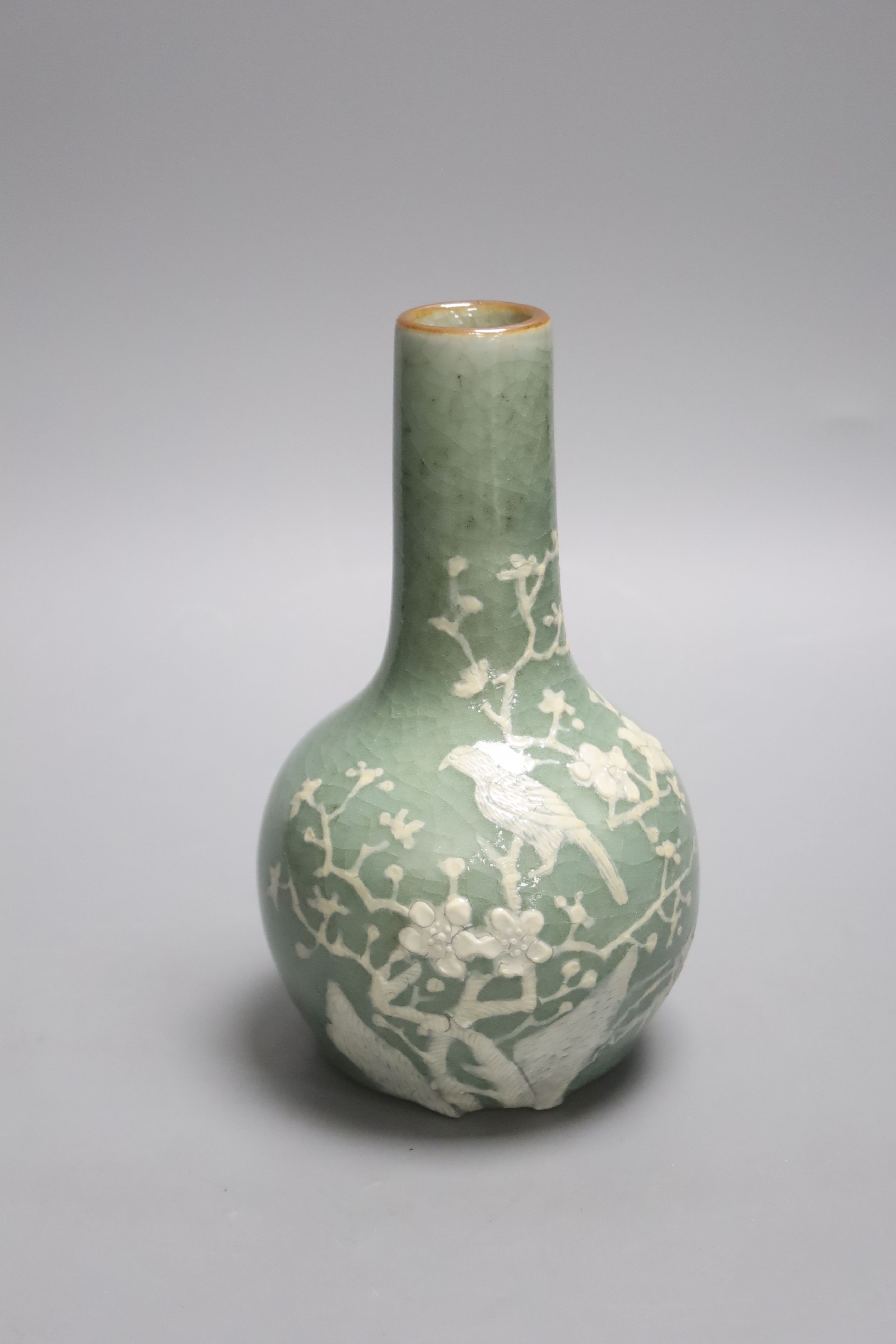 A Chinese celadon bottle vase with white slip decoration, 19th/20th century, height 20cm